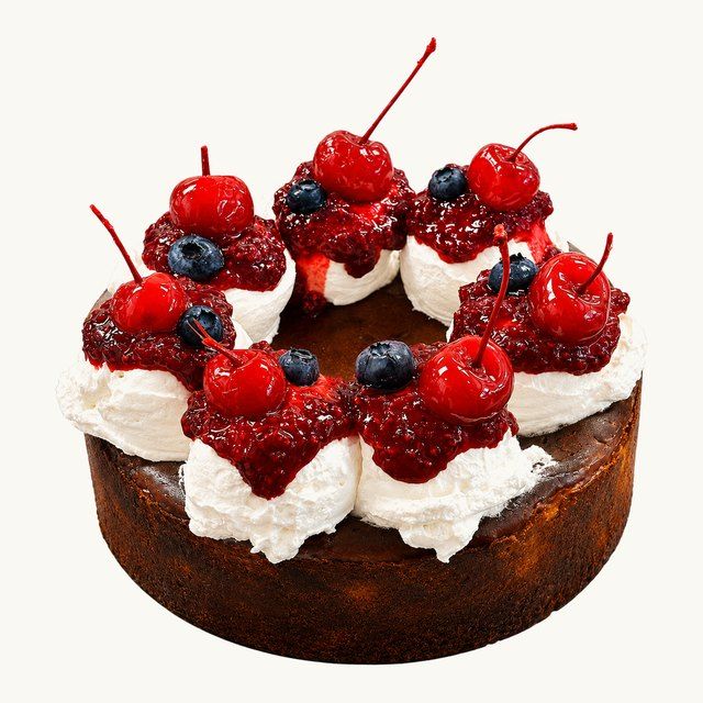 Plain Basque Cheesecake with whipped cream, raspberry jam and cherries